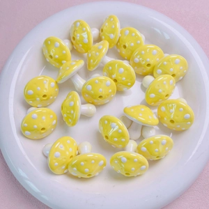 Detailed view of yellow spotted mushroom acrylic beads for handmade DIY jewelry crafting