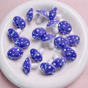 Macro shot of purple mushroom acrylic beads with white dots for DIY jewelry making