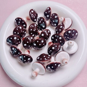 Macro detail of brown polka dot ceramic mushroom beads for handmade jewelry DIY projects
