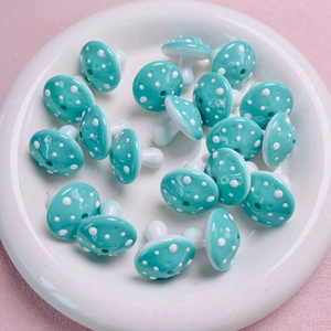 Macro detail of acrylic mushroom beads with polka dots for DIY jewelry making