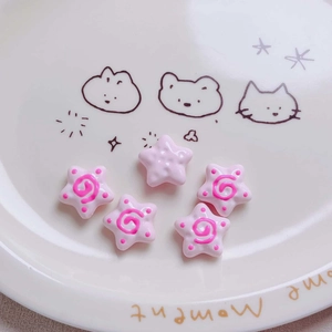 Detailed view of pink acrylic star beads with spiral patterns for DIY jewelry crafts
