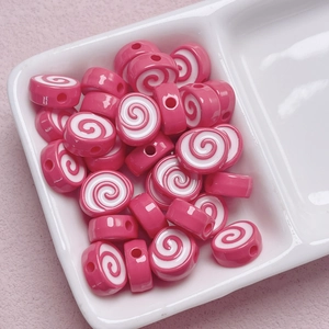Macro detail of pink and white spiral acrylic beads for DIY jewelry and phone charms