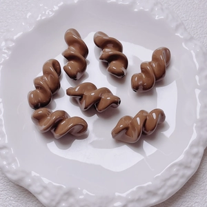 Close-up of brown acrylic spiral twist beads for DIY jewelry and mobile phone chains