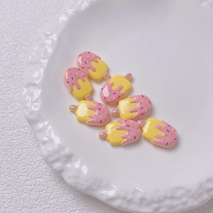 Close-up van gele en roze ijsvormige acrylkralen voor DIY-sieraden en knutselwerkjes