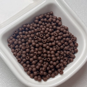 Macro shot of 4mm matte brown rubberized spacer beads for DIY jewelry making and crafts
