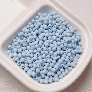 Macro detail of 4mm light blue dopamine seed beads for DIY jewelry and phone chain making
