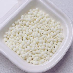 Macro view of 4mm cream rubberized beads for DIY jewelry making and phone charms