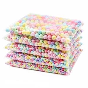 Multiple bags of colorful macaron acrylic beads for DIY jewelry and phone chain making