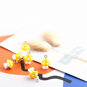 Set of six yellow resin mushroom charms with white polka dots for DIY jewelry making