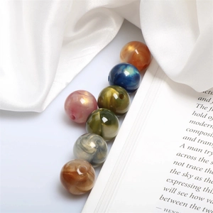 Macro shot of 15mm colorful acrylic beads with pearlescent marble texture for DIY jewelry