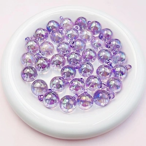 Close-up of 16mm purple iridescent acrylic candy beads with hangers in a white dish