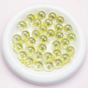 Close-up of 16mm light yellow translucent AB coating acrylic beads for jewelry making