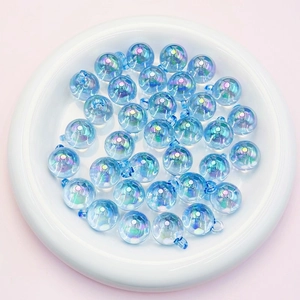Macro detail of 16mm iridescent light blue candy beads with eyelets for DIY jewelry