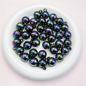 Macro detail of 16mm iridescent UV plated acrylic beads with metal ring for DIY jewelry