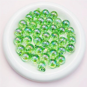 Detail view of emerald green UV coated candy beads with hanging loops for DIY jewelry