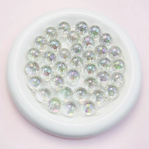 Detail view of 16mm transparent UV coated AB rainbow acrylic round beads in a white tray