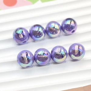 Macro shot of 16mm purple iridescent UV coated rabbit beads for DIY jewelry making