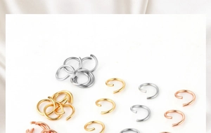 Close-up of gold, silver and rose gold metal open jump rings for DIY jewelry making