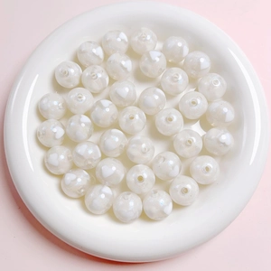 Detailed macro view of 16mm white acrylic beads with sparkling hearts for DIY jewelry
