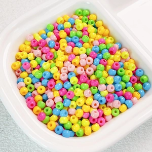 Detail of colorful 4mm uniform Czech glass seed beads in a white bowl for DIY jewelry making
