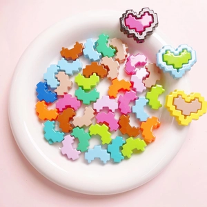 Colorful acrylic pixel heart beads and U-shaped DIY jewelry components on a tray