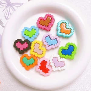 Macro shot of colorful acrylic pixel heart beads for DIY jewelry and phone chain making