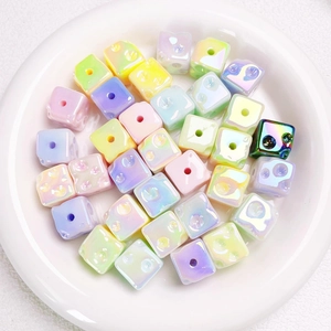 Close-up of colorful UV coated star-glow cheese cube beads for DIY crafts making