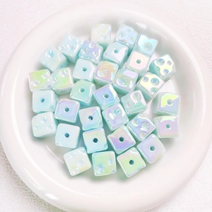 Macro shot of blue iridescent cube beads with dot design and center hole for jewelry making