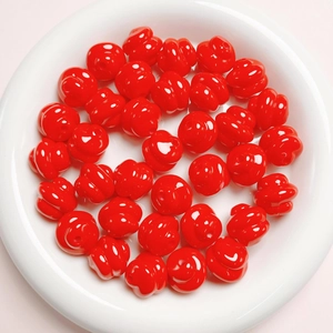 Macro view of bright red glossy grooved round beads for DIY jewelry making
