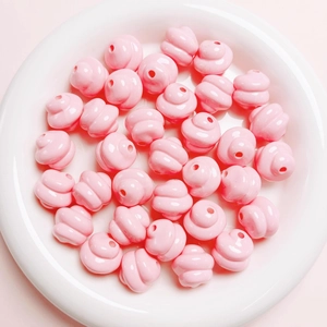 Macro detail of glossy pink resin spiral beads for DIY jewelry and phone chains