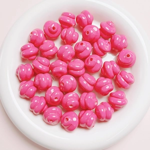 Macro view of bright pink spiral craft beads for DIY jewelry making in a white tray