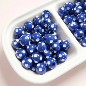 Close-up of 12mm dark blue resin beads with white polka dots for DIY jewelry making
