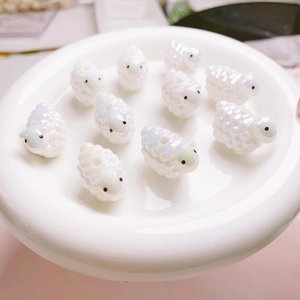 Detailed view of iridescent cartoon sheep beads for DIY jewelry making and crafts