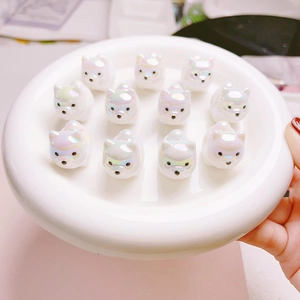 Detailed macro view of 3D UV plated Shiba Inu cartoon beads with iridescent pearl finish