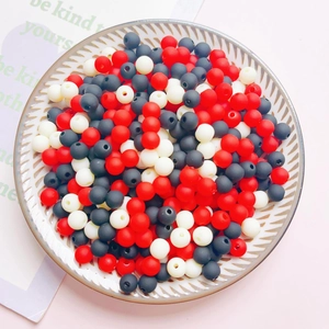 Macro shot of colorful 6mm acrylic beads in red black and white for DIY craft making