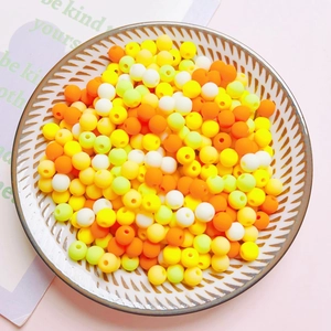 Macro shot of colorful 6mm acrylic matte round beads in a bowl for DIY jewelry making