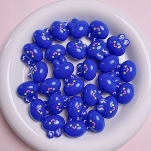 Macro view of blue 20mm acrylic rabbit beads with cute faces for DIY jewelry crafts