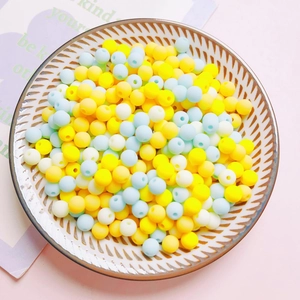 Detail of 6mm matte acrylic beads in yellow, blue and white for DIY craft making