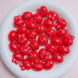 Detail of 20mm red acrylic rabbit charms with cartoon smiles for DIY jewelry crafts