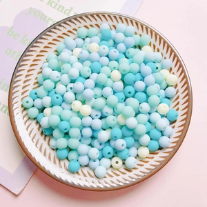 Macro detail of matte pastel acrylic beads in a ceramic tray for DIY jewelry making