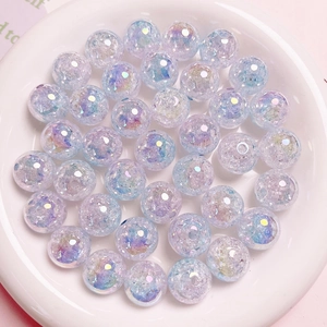 Detail of 16mm dual-color gradient UV beads with crackle effect in a white ceramic dish