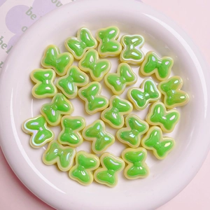 Light green macaron bow beads with pearlescent finish for DIY jewelry crafts