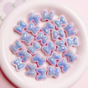 Macro view of colorful resin bow beads with pearlescent finish for DIY jewelry crafting