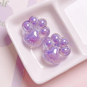 Macro detail of purple transparent acrylic cat paw beads with aurora gradient texture