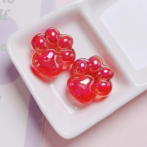 Close-up of translucent red acrylic cat paw beads for DIY phone chain and crafts