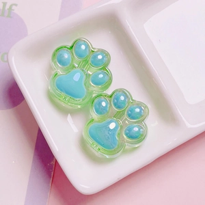 Close-up of cute green and blue acrylic cat paw beads for DIY phone chain making