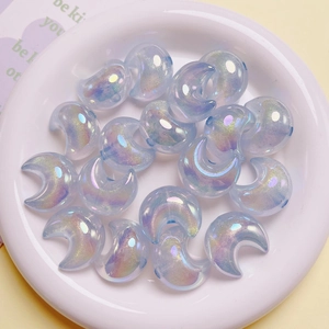 Macro detail of iridescent crescent moon beads with aurora coating for DIY jewelry making
