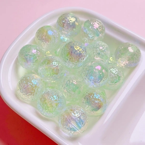Detail of dreamy iridescent cracked glass beads for DIY jewelry in a ceramic dish