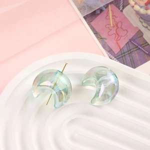 Macro view of iridescent crescent moon beads with aurora finish for DIY jewelry crafts