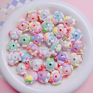 Macro view of hand-painted cartoon acrylic beads for DIY jewelry and phone charms